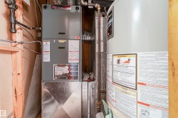 Utility room with gas water heater and heating unit - 