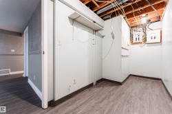 Unfinished below grade area featuring light wood-style flooring and electric panel - 