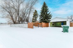 Snowy yard featuring a gate - 