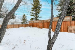 Yard layered in snow featuring a fenced backyard - 