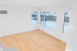 Empty room featuring light wood-type flooring, healthy amount of natural light, and recessed lighting - 