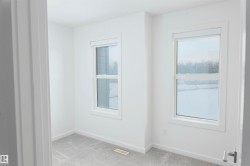 Carpeted spare room featuring baseboards - 