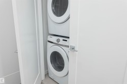 Laundry room with stacked washing machine and dryer - 