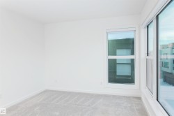 Carpeted spare room featuring baseboards - 