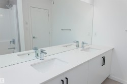 Bathroom with double vanity and bathtub / shower combination - 