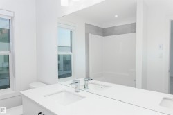 Full bath with double vanity and a shower - 