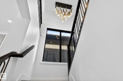 Stairs with a chandelier and a high ceiling - 