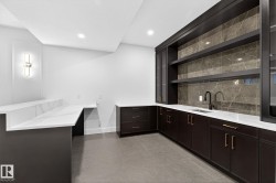Bar with open shelves, light stone countertops, backsplash, recessed lighting, and light tile patterned floors - 