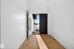 Doorway with baseboards and wood finished floors - 