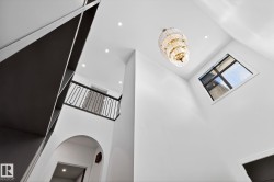Detailed view of recessed lighting, a chandelier, and arched walkways - 