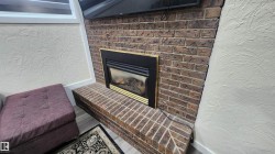 Detailed view of a brick fireplace and a textured wall - 