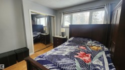Bedroom with light wood-type flooring, a closet, and a textured ceiling - 