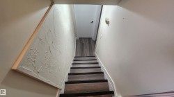 Stairs featuring wood finished floors - 