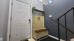 Mudroom with light flooring and a high ceiling - 
