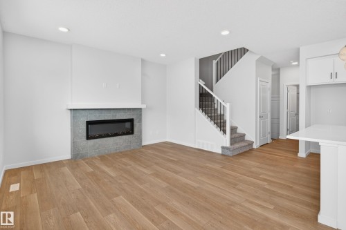 5008 72 Street, Beaumont, AB - Indoor Photo Showing Living Room With Fireplace