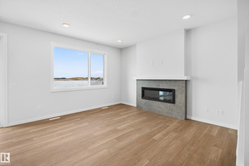 5008 72 Street, Beaumont, AB - Indoor Photo Showing Living Room With Fireplace