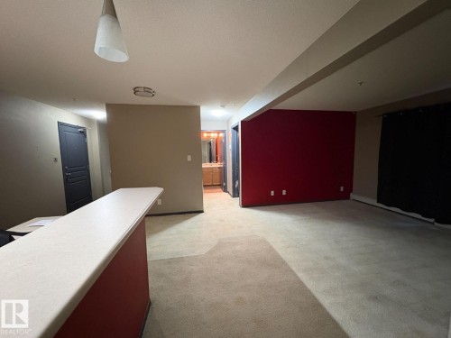 Bar featuring light colored carpet, light countertops, and baseboard heating - 231 1180 Hyndman Road, Edmonton, AB - Indoor Photo Showing Other Room