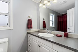 Bathroom featuring vanity, a shower with shower curtain, and a textured ceiling - 