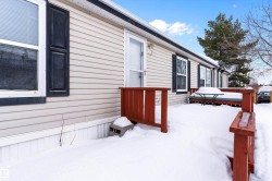 View of snow covered exterior with a deck - 