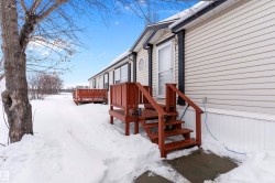 View of snowy exterior featuring a deck - 