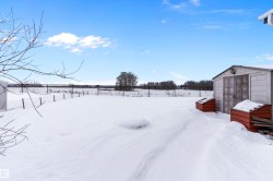 Snowy yard with a storage shed - 