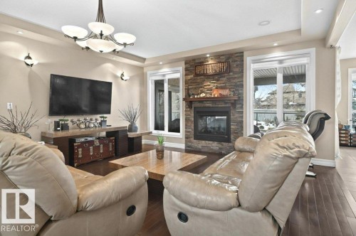 4835 Mactaggart Crest Crest, Edmonton, AB - Indoor Photo Showing Living Room With Fireplace