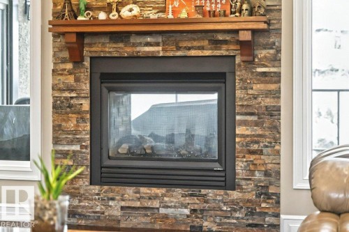 4835 Mactaggart Crest Crest, Edmonton, AB - Indoor Photo Showing Other Room With Fireplace