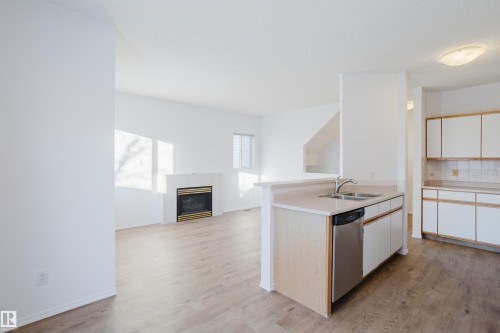 57 843 Youville Drive W, Edmonton, AB - Indoor Photo Showing Kitchen With Fireplace With Double Sink