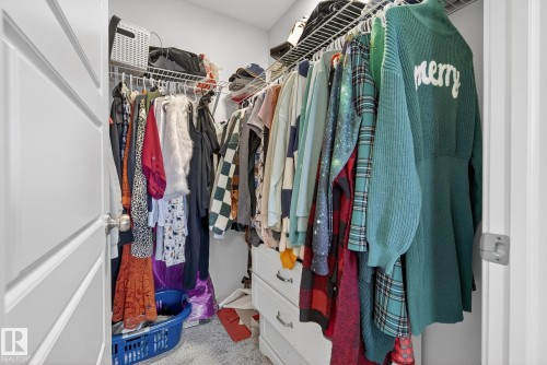 This property features a closet with a white paneled door, offering organized storage with wire shelving and hanging rods - 8 Daniel Street, Fort Saskatchewan, AB - Indoor With Storage