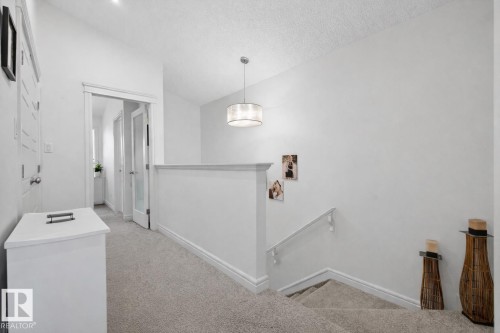 The property features light-colored carpeting, white walls, and a modern ceiling light fixture - 8 Daniel Street, Fort Saskatchewan, AB - Indoor
