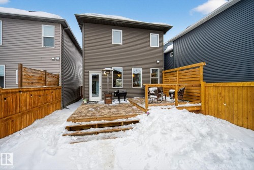The property features a private backyard with a wood deck, wood fencing, and a door providing exterior access - 8 Daniel Street, Fort Saskatchewan, AB - Outdoor With Deck Patio Veranda With Exterior