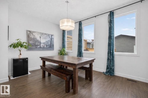 This room features light-colored walls and large windows, providing abundant natural light - 8 Daniel Street, Fort Saskatchewan, AB - Indoor Photo Showing Dining Room