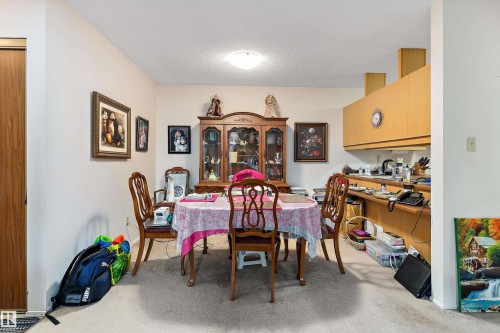Dining area featuring a textured ceiling and light carpet - 305 32 Alpine Place, St. Albert, AB - Indoor Photo Showing Other Room