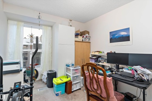 Carpeted office space featuring a textured ceiling - 305 32 Alpine Place, St. Albert, AB - Indoor Photo Showing Office