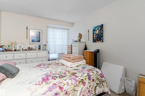 Carpeted bedroom with a textured ceiling - 305 32 Alpine Place, St. Albert, AB - Indoor Photo Showing Bedroom
