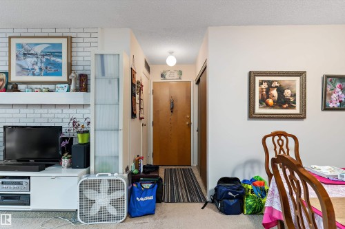 Carpeted foyer entrance featuring a textured ceiling - 305 32 Alpine Place, St. Albert, AB - Indoor