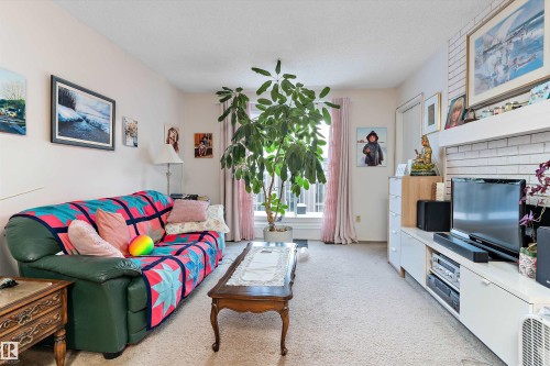Living room featuring light carpet - 305 32 Alpine Place, St. Albert, AB - Indoor Photo Showing Other Room