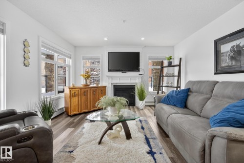 134 11505 Ellerslie Road, Edmonton, AB - Indoor Photo Showing Living Room With Fireplace