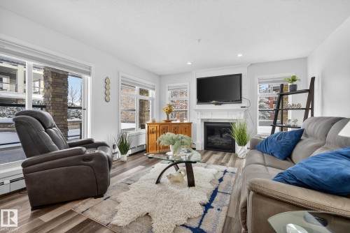 134 11505 Ellerslie Road, Edmonton, AB - Indoor Photo Showing Living Room With Fireplace