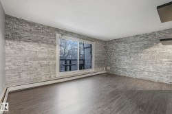 Spare room featuring baseboard heating, dark wood-style flooring, and a baseboard heating unit - 