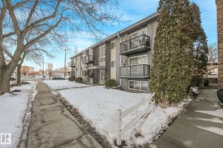 Snow covered property featuring a view of apartment building / complex - 