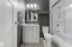 Full bathroom with vanity and enclosed tub / shower combo - 