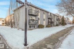 Snow covered property with a view of apartment building / complex - 
