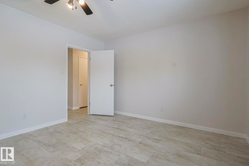 Spare room featuring ceiling fan and light floors - 13419 102 Street, Edmonton, AB - Indoor Photo Showing Other Room
