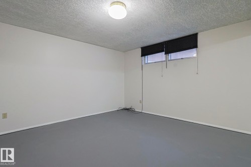 Basement featuring a textured ceiling - 13419 102 Street, Edmonton, AB - Indoor Photo Showing Other Room