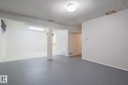 Finished below grade area featuring a textured ceiling - 