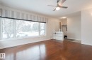 Unfurnished living room with dark wood-type flooring and ceiling fan - 13419 102 Street, Edmonton, AB  - Indoor Photo Showing Other Room 