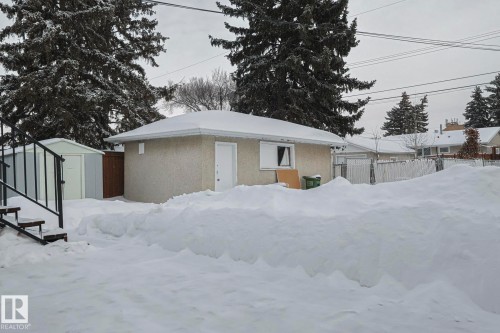 View of snowy exterior with stucco siding and a shed - 13419 102 Street, Edmonton, AB - Outdoor