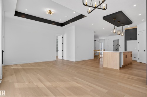 Spacious open-concept interior featuring light hardwood floors and recessed lighting - 27 Rosewood Way, St. Albert, AB - Indoor