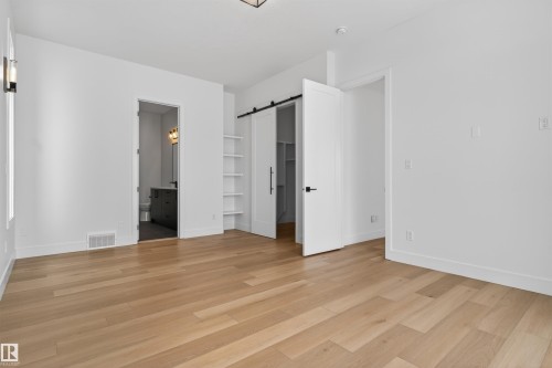 This room features hardwood floors and crisp white walls - 27 Rosewood Way, St. Albert, AB - Indoor Photo Showing Other Room